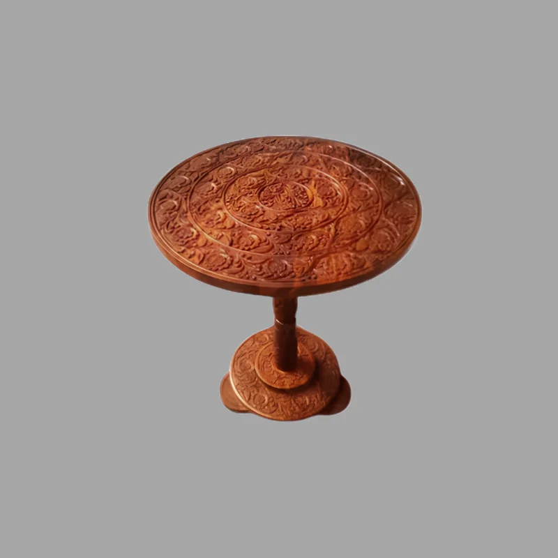 Round sheesham side table with dense floral carving across the top and pedestal