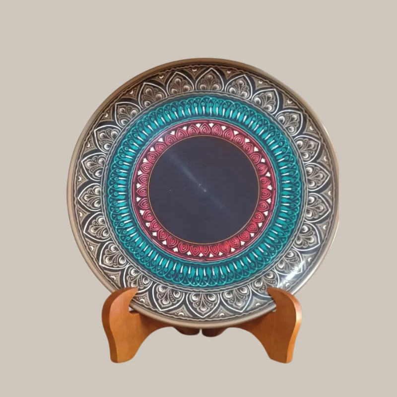 Turned wooden display plate with concentric patterned rings on a wooden stand
