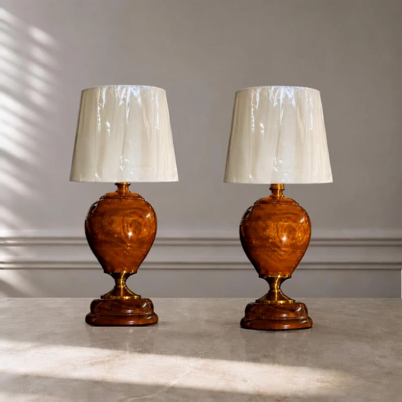 Row of amber lacquered table lamp bodies with brass-toned fittings