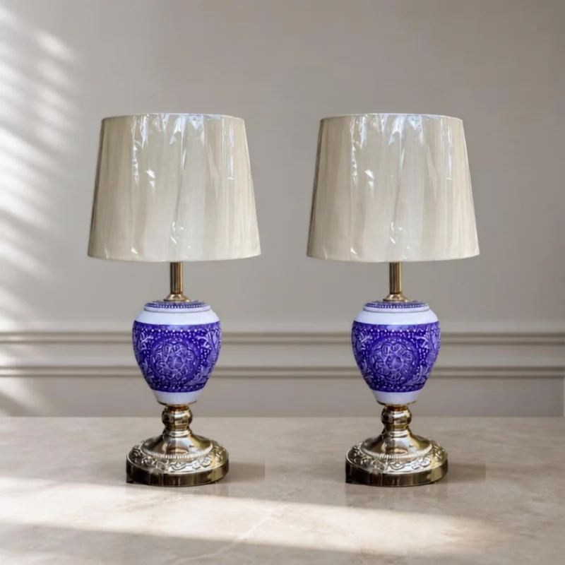 Lacquered wooden table lamp with a patterned body and a fabric shade