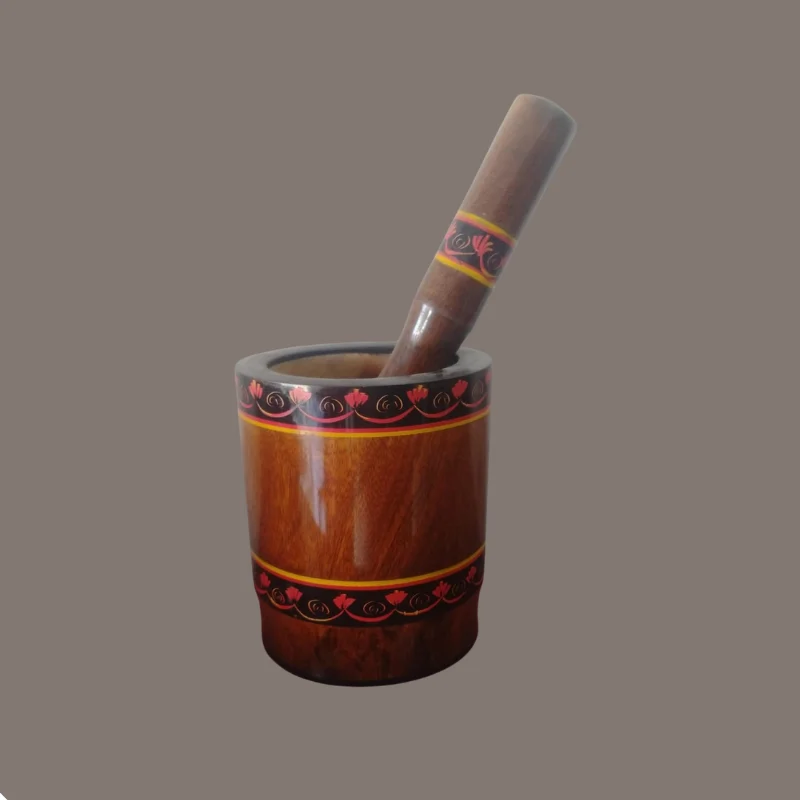 Red-polished wooden mortar with the pestle standing inside it