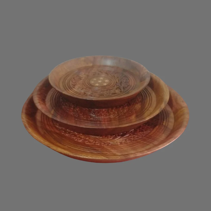 Three nested sheesham plates with hand-carved floral centres