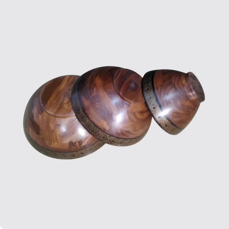 Underside of the three sheesham bowls showing the wood grain and the gold naqshi band
