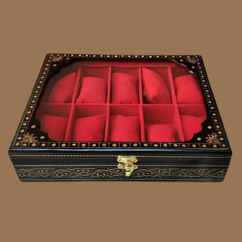 10-slot watch box in black and gold naqshi lacquer with a glass lid, red velvet watch pillows and a brass clasp