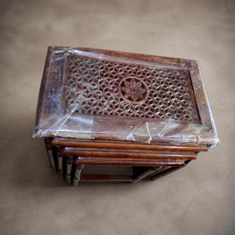 Stack of nesting tables with deeply carved lattice tops and a central rosette