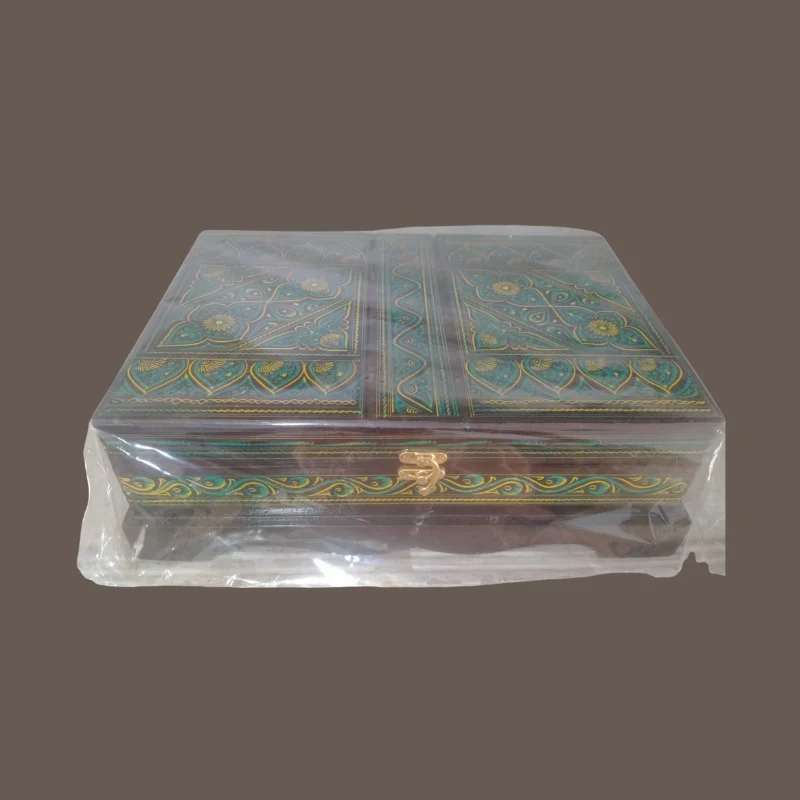Red and gold lacquered Quran box open to show the red cloth lining