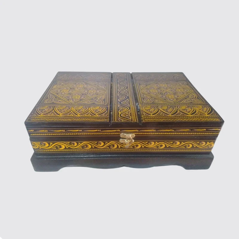 Red and gold lacquered Quran box open to show the red cloth lining