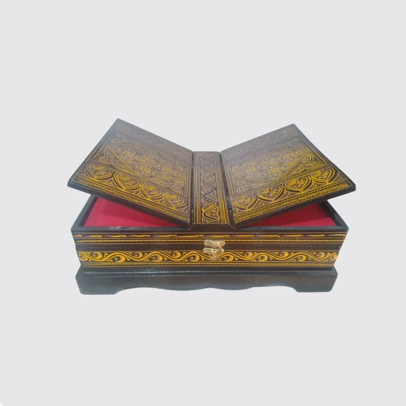 Red and gold lacquered Quran box open to show the red cloth lining