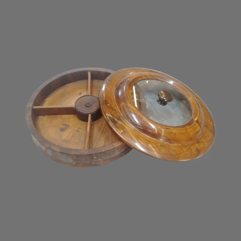 The dry fruit box with its glass lid lifted, showing the four compartments inside