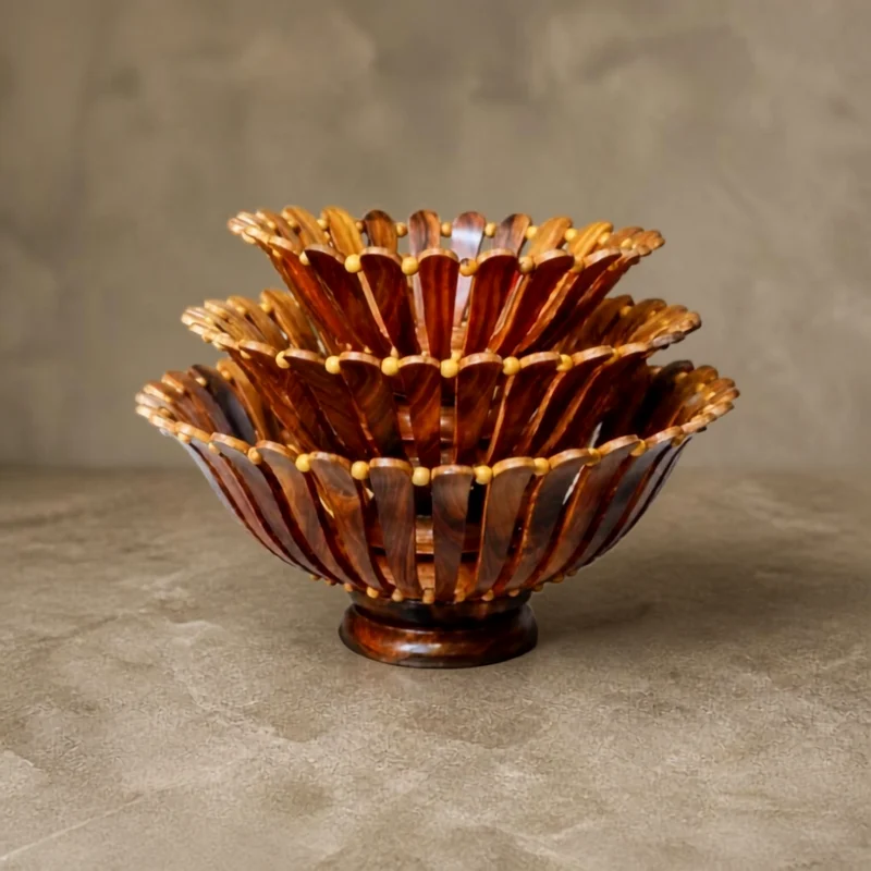 Single handmade sheesham fruit basket with three fixed tiers of carved slats, beaded rims and a turned pedestal foot