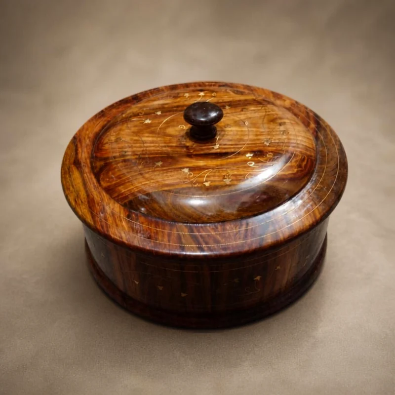 Twelve inch sheesham wooden hot pot with a lifted lid showing brass inlay scrollwork and a turned knob
