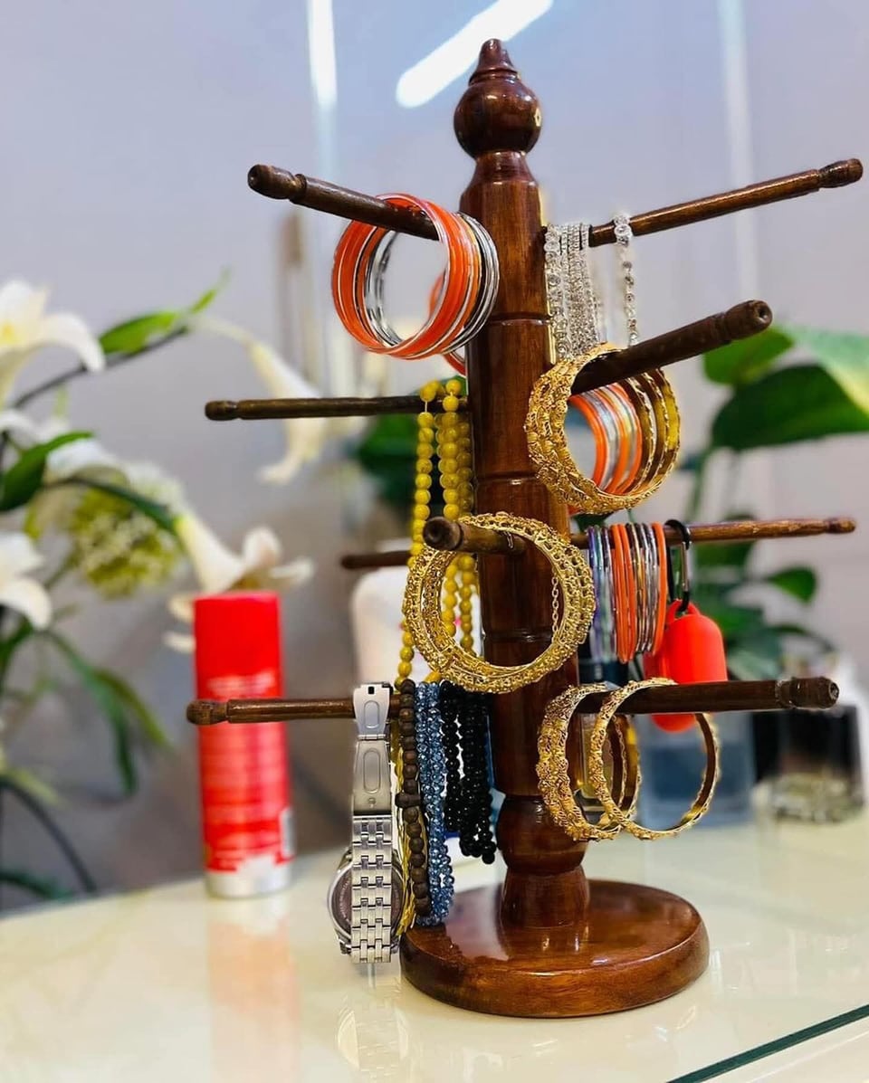 Wooden bangle stand with arms holding bangles and chains