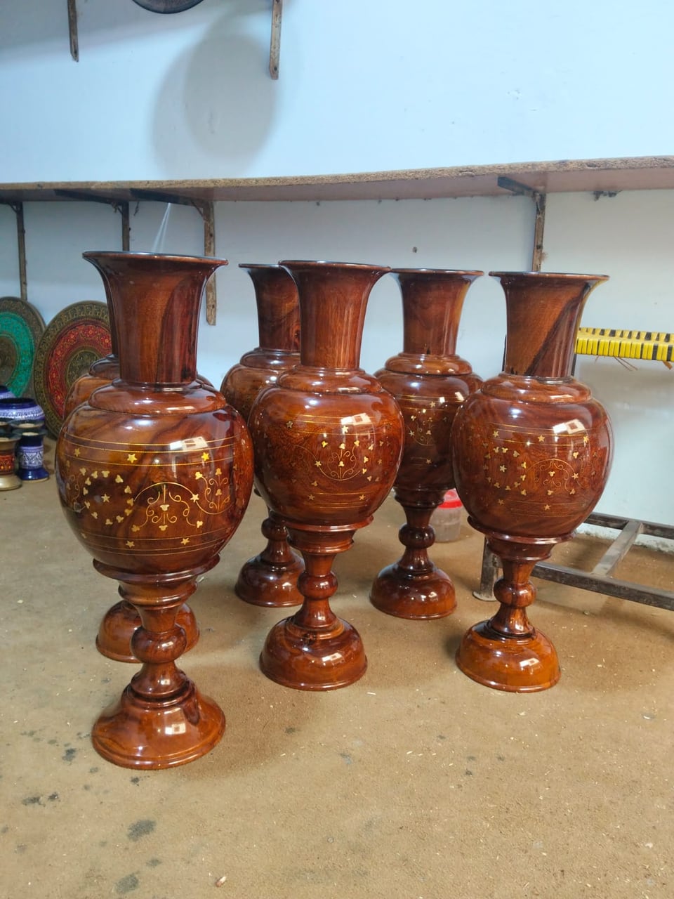 Tall wooden flower vases with brass inlay patterns