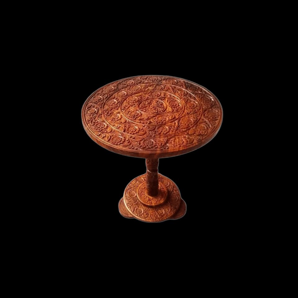 Round sheesham side table with dense floral carving across the top and pedestal