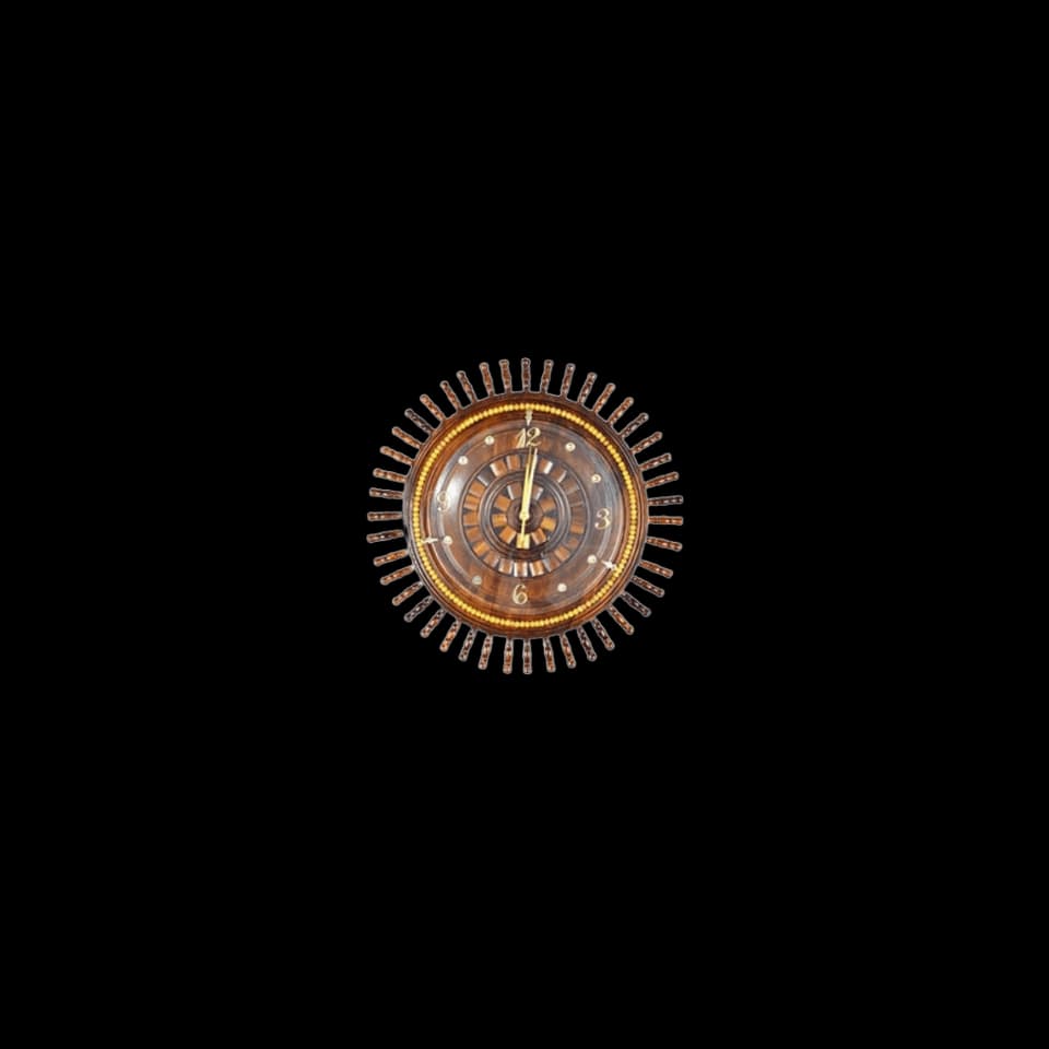 Round sheesham wall clock surrounded by carved sunburst rays