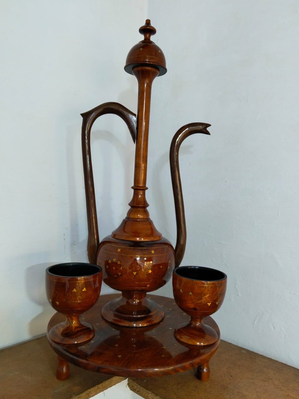 Decorative wooden surahi jug with cups on a matching tray