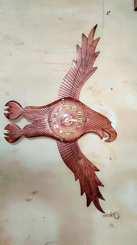 Wall clock carved in the shape of an eagle with open wings