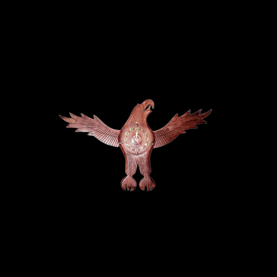 Wall clock carved as an eagle with spread wings and the dial set in its chest