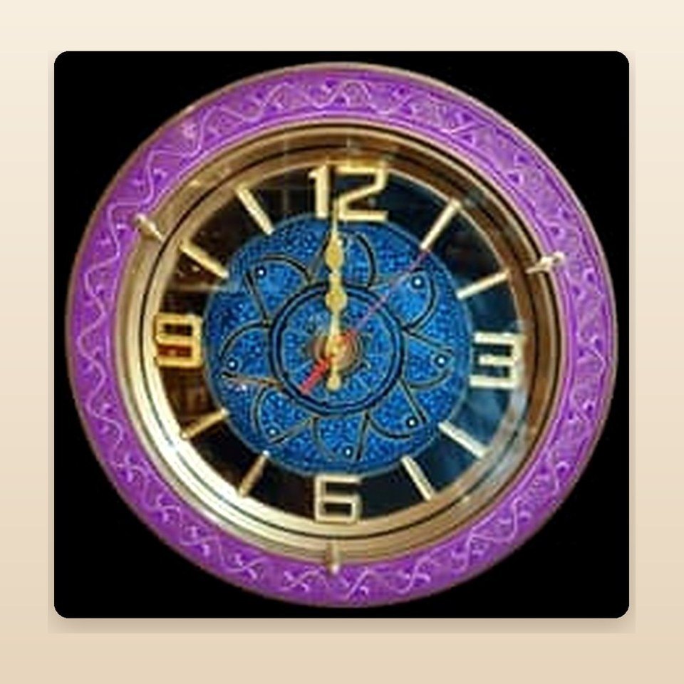 Round wall clock with a purple and gold naqshi face and gold hands