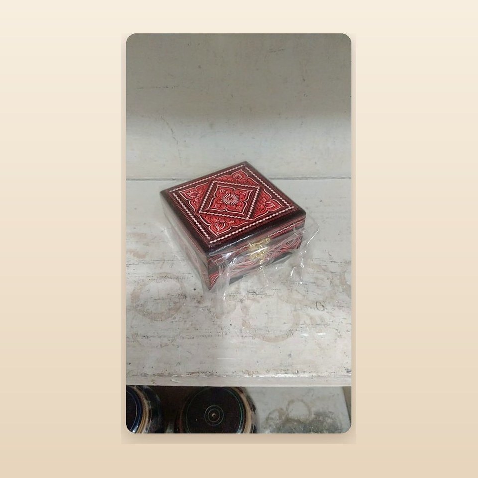 Small square box with a red floral lacquered lid on a dark base