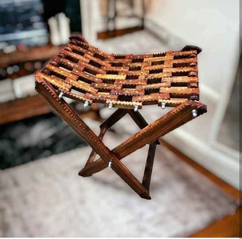 Small folding wooden stool with a woven leather seat