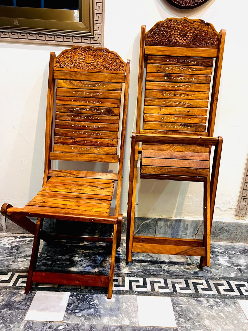 Carved wooden folding chair with a woven seat