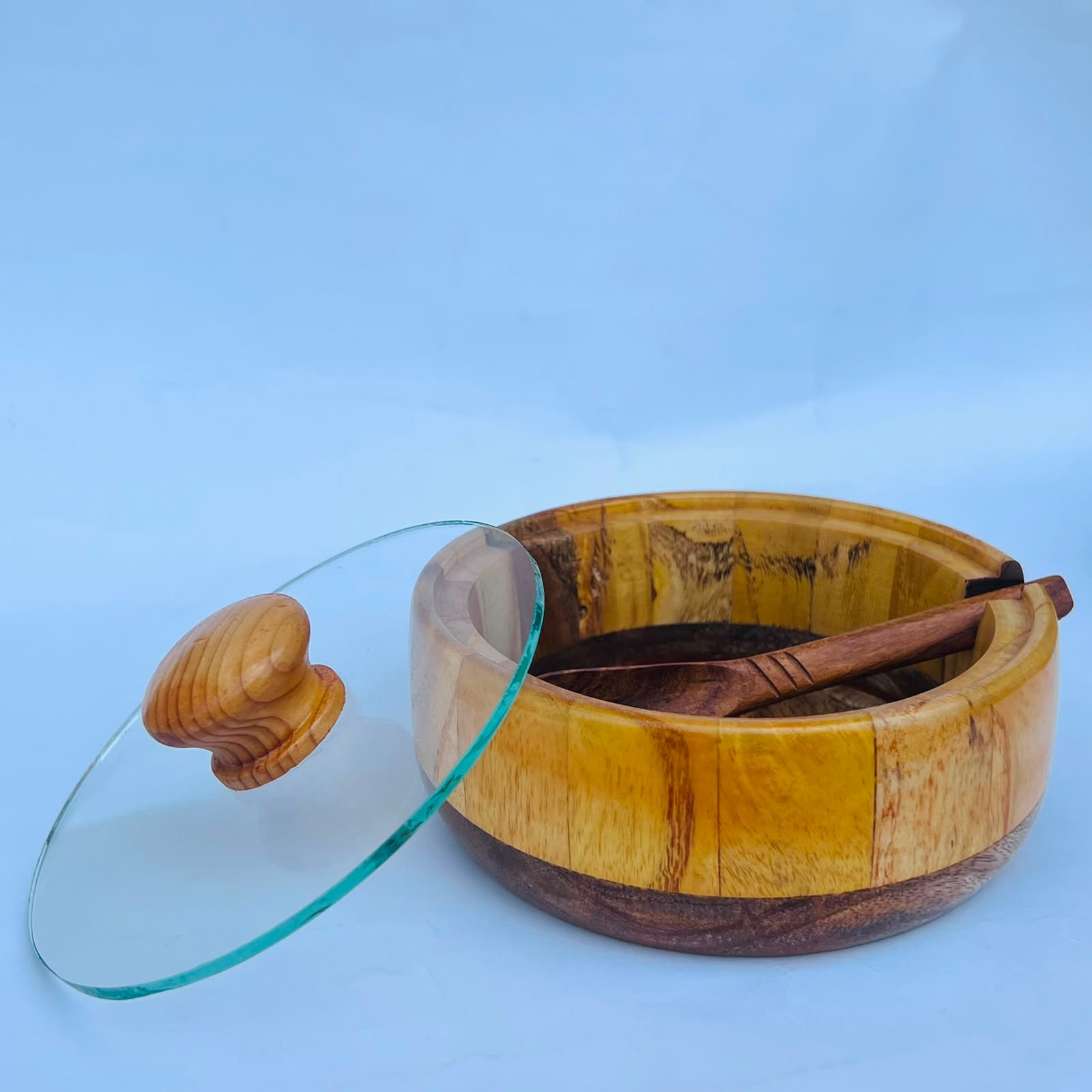 Wooden hot pot with a glass lid and matching wooden spoon