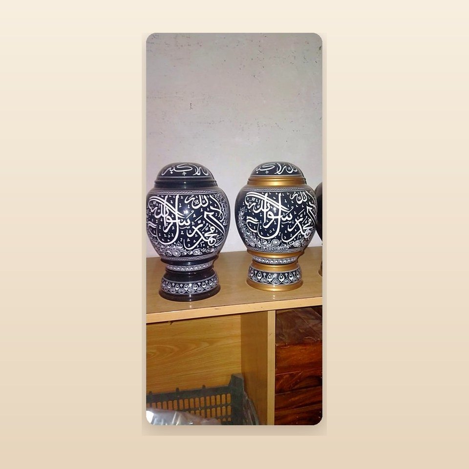 Two dark blue lidded wooden jars with the Kalima written around them in white