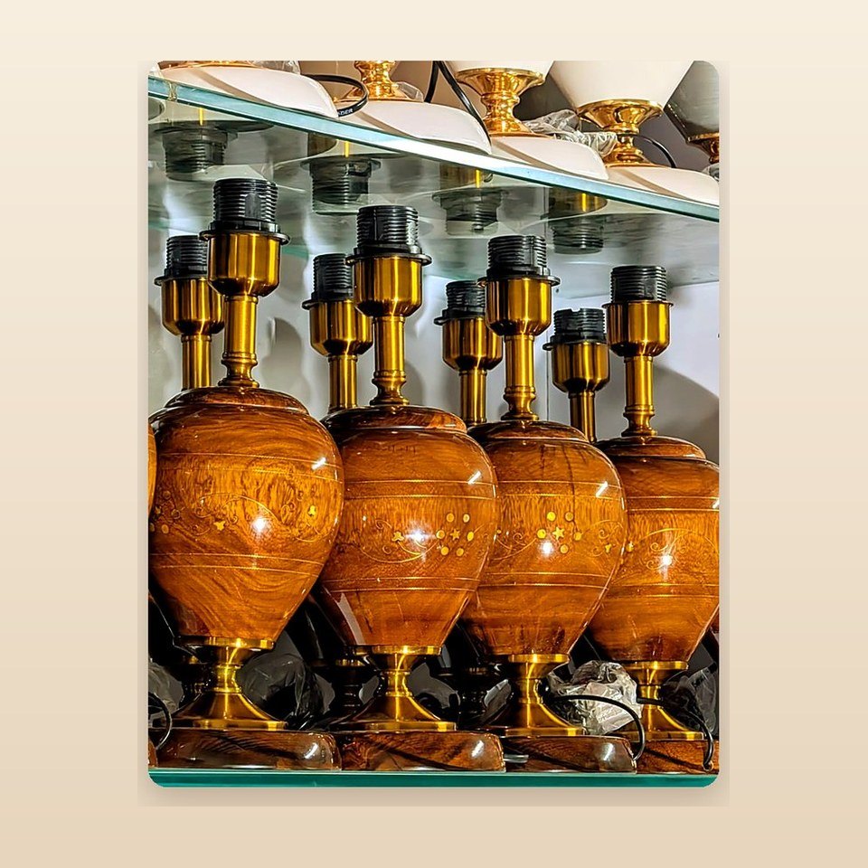 Row of amber lacquered table lamp bodies with brass-toned fittings