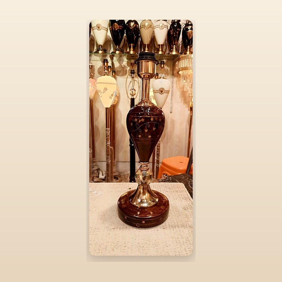 Tall lacquered lamp body with a star pattern raised on a slim metal stem