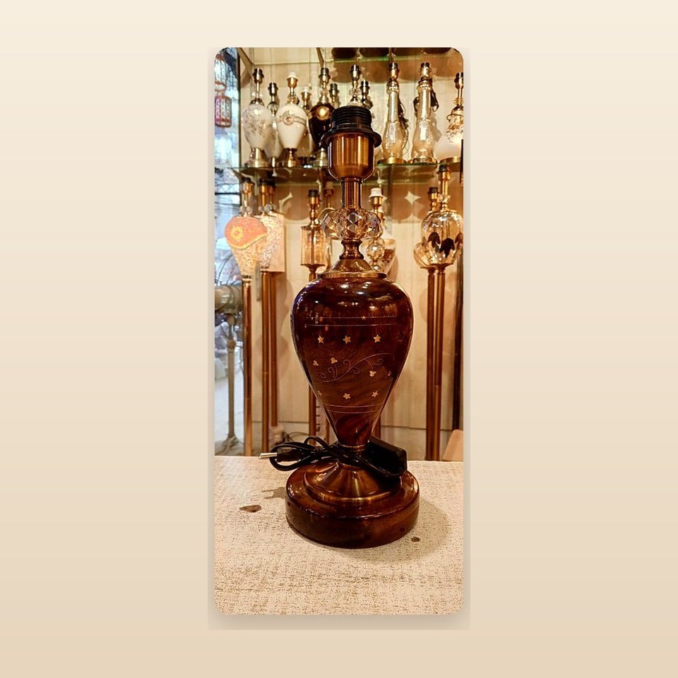 Deep red lacquered lamp body with a scattered star pattern on a turned foot