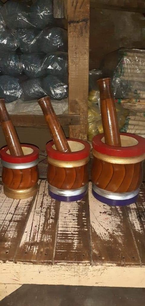 Wooden mortar and pestle with a painted band around the base