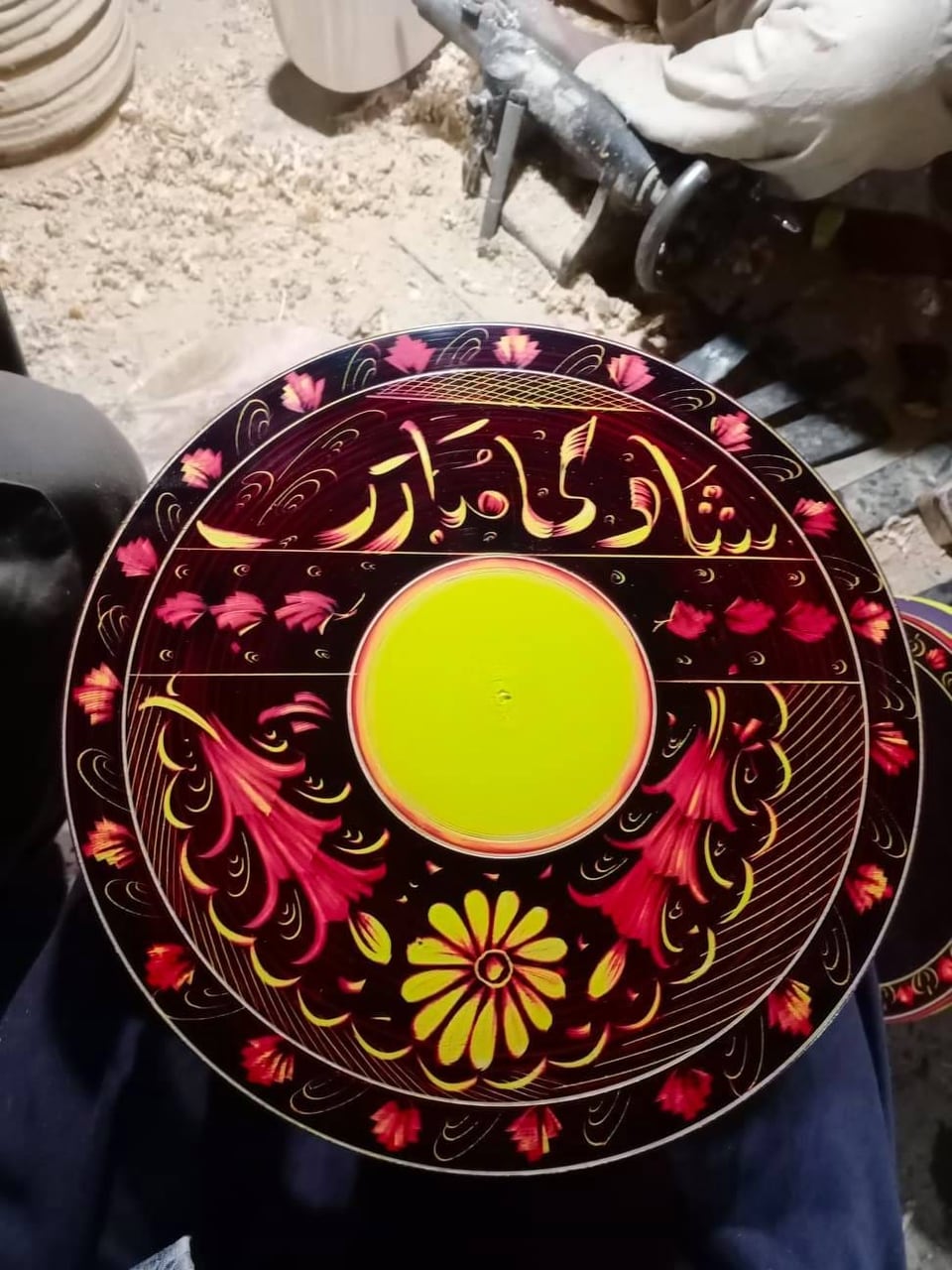 Hand-painted naqshi display plate in red, yellow and black