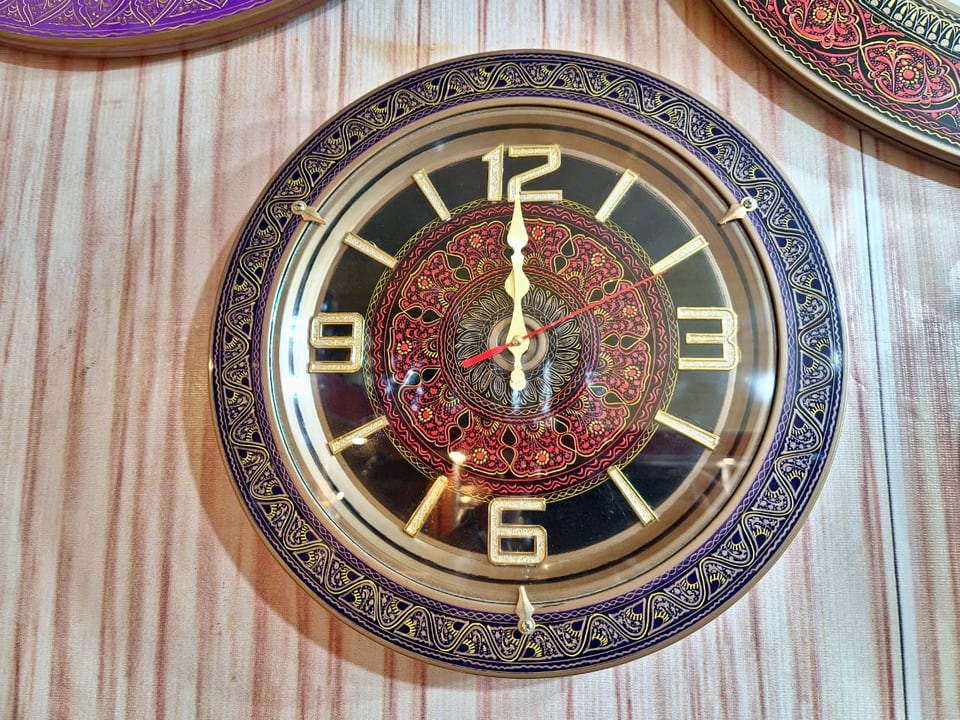 Round wall clock with hand-painted naqshi patterns on the face and rim