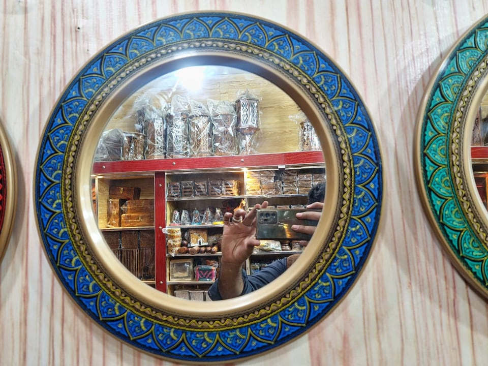 Round wall mirror in a hand-painted naqshi frame