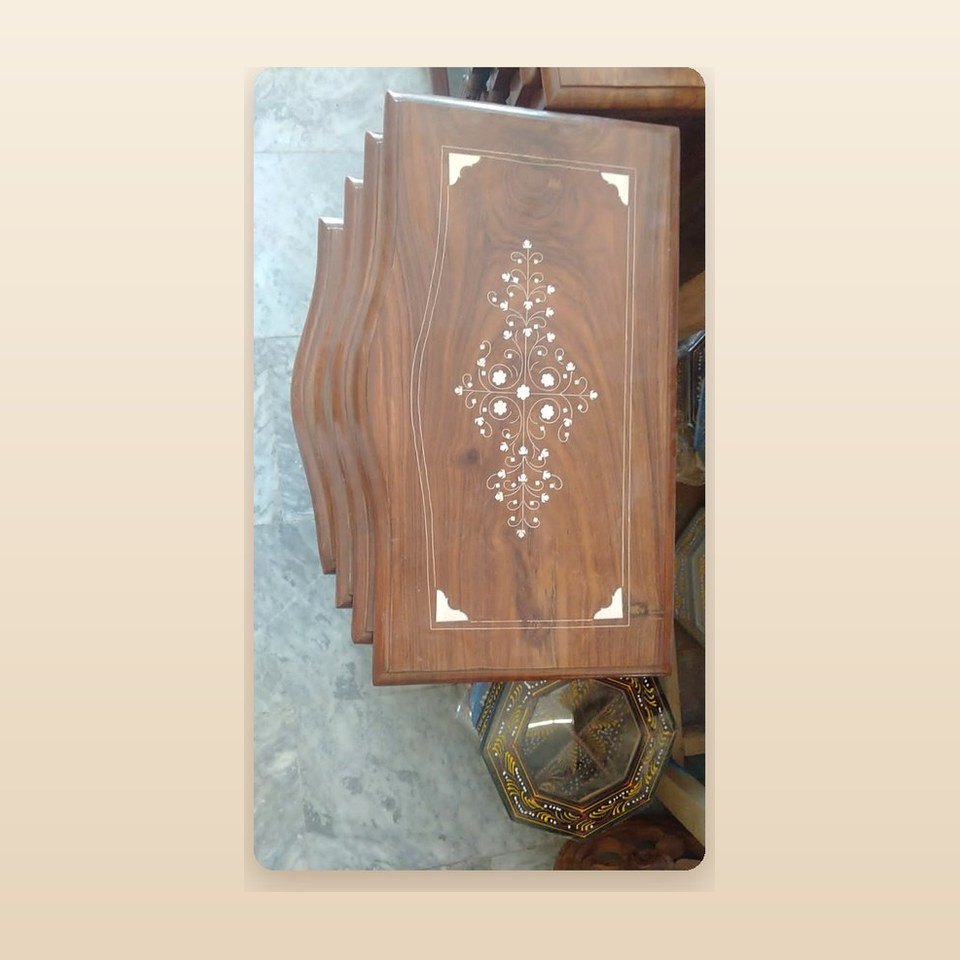 Carved sheesham table top with a white inlay pattern running down the centre