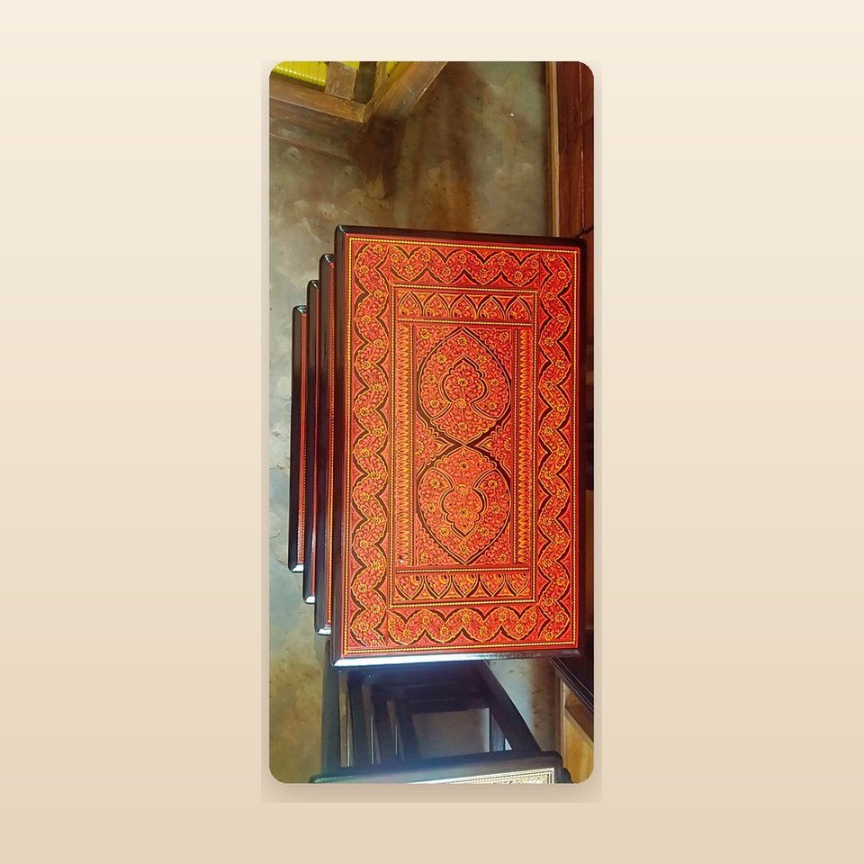 Nesting table set with orange lacquer tops patterned in fine naqshi scratchwork
