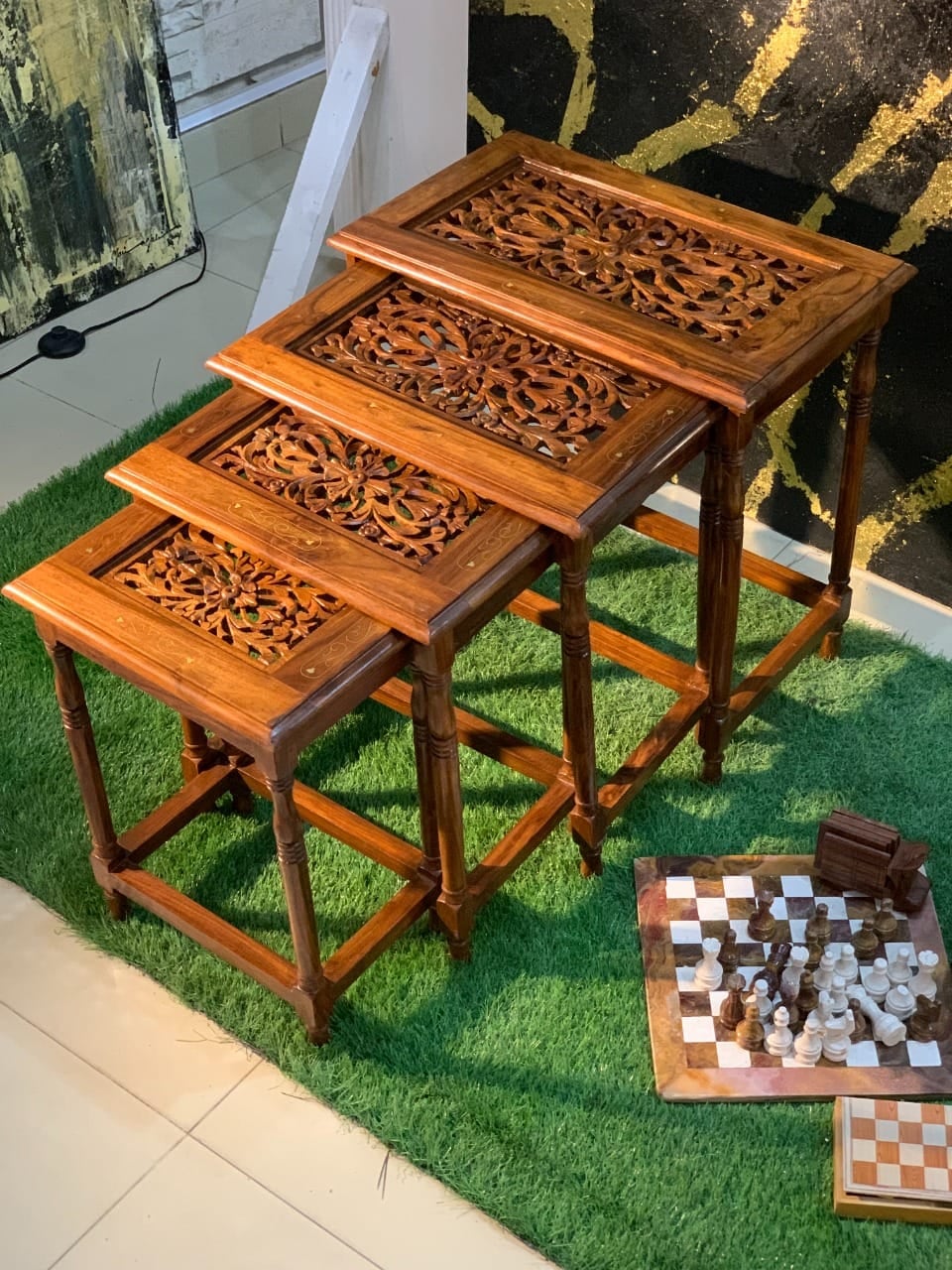 Set of four carved wooden nesting tables