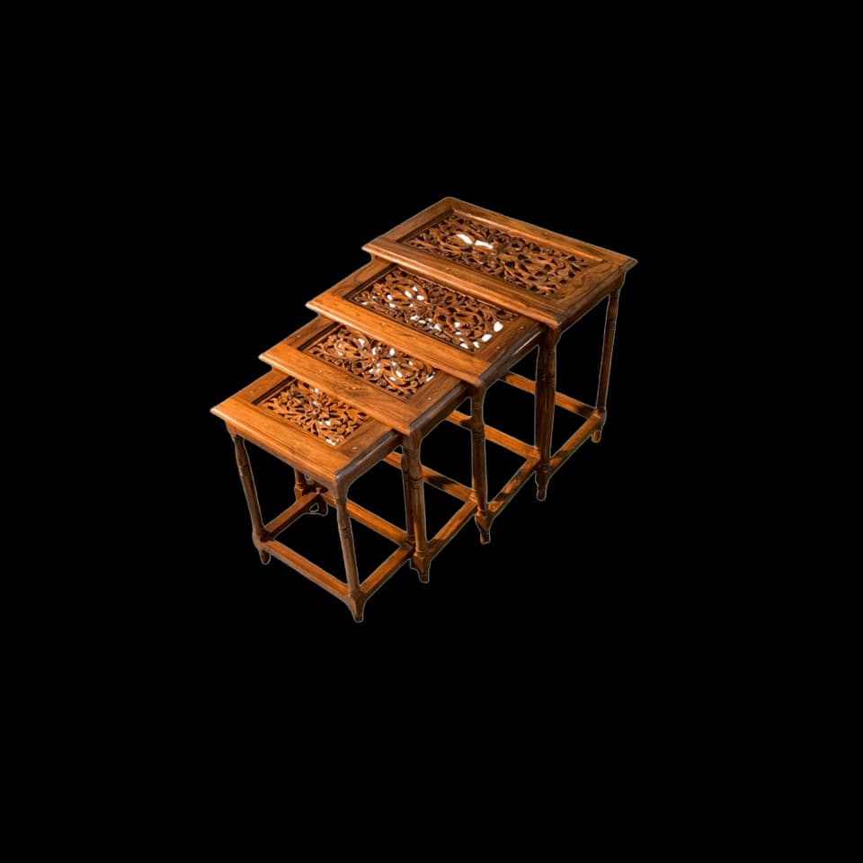 Three sheesham nesting tables with carved openwork tops, stacked under each other
