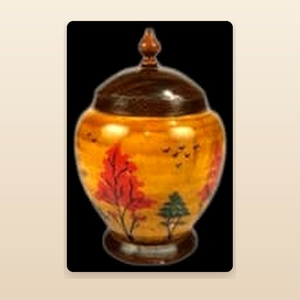 Amber lacquered lidded jar hand-painted with a tree and hillside scene
