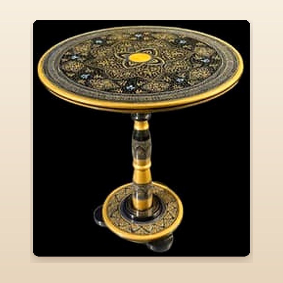 Round pedestal table with a black and gold naqshi top and a banded turned stem