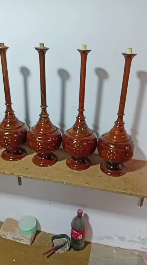 Tall turned wooden table lamp bases in the workshop