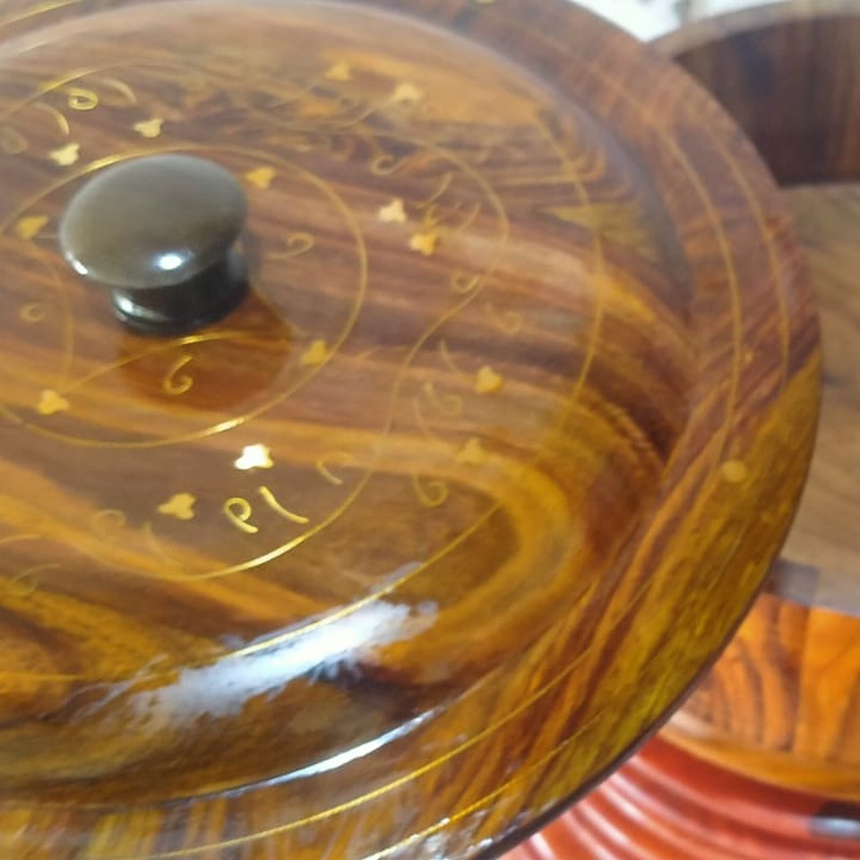 Twelve inch sheesham wooden hot pot with a lifted lid showing brass inlay scrollwork and a turned knob