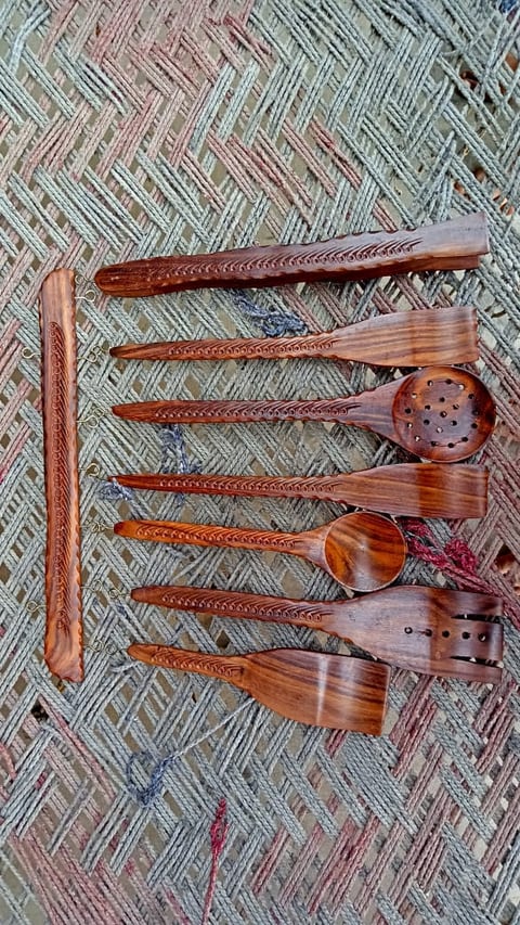 Set of wooden cooking and serving spoons with brass dot detail